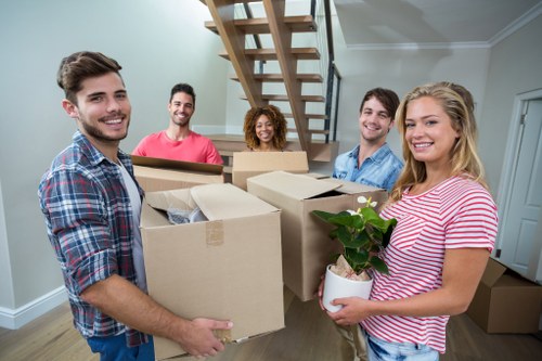 Movers loading boxes and household items into a van