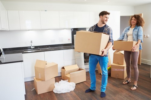 Removal van and moving crew handling furniture near Towerhill properties
