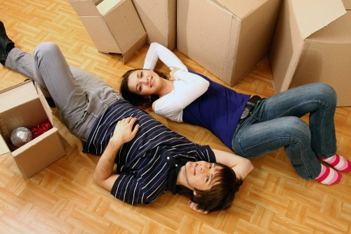 Moving van and office furniture outside a central London commercial building