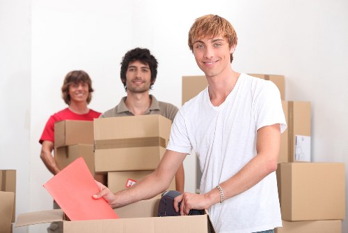 Professional movers loading items into a vehicle for a local Towerhill relocation